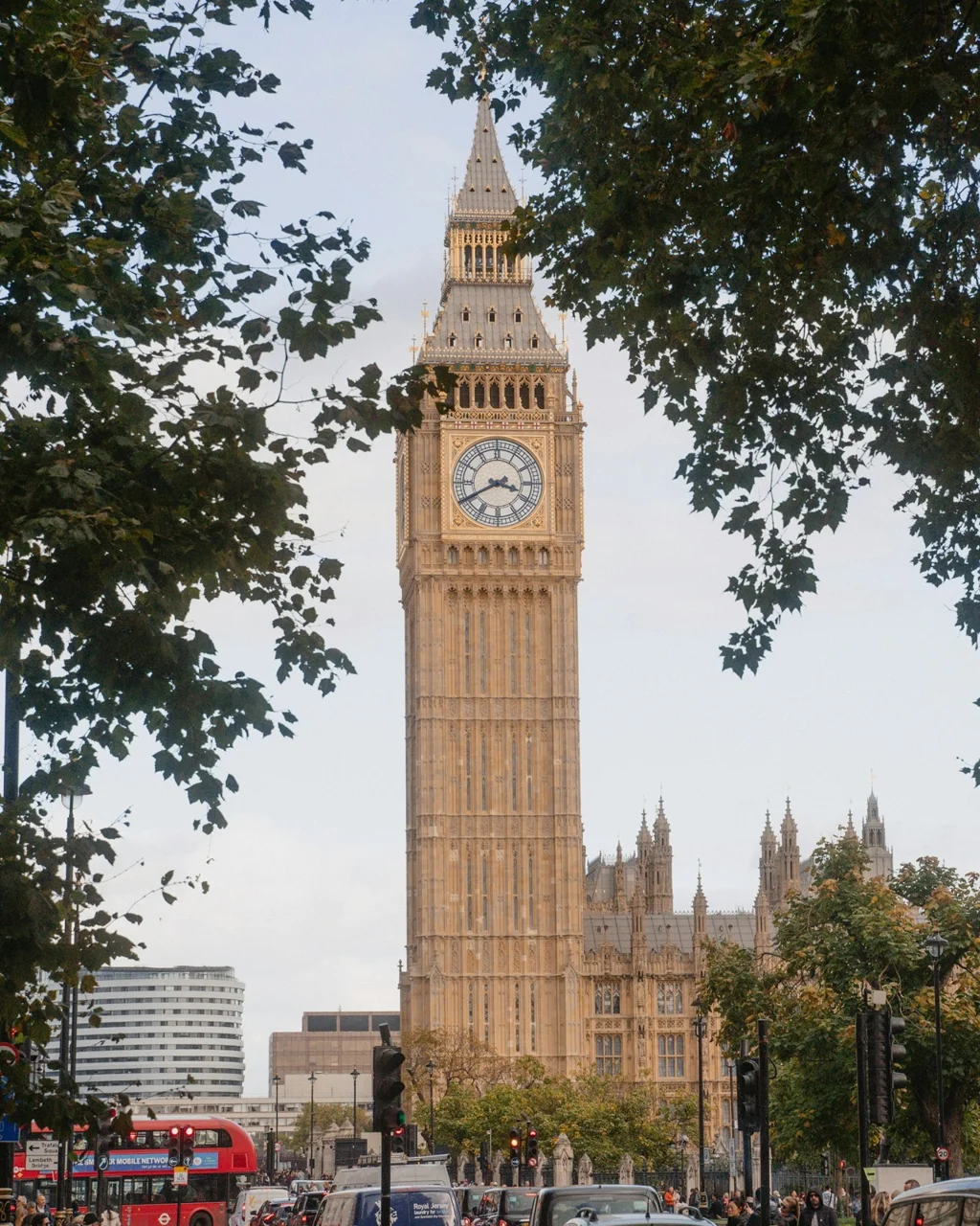 Before: Big Ben framed by trees above a busy London street
