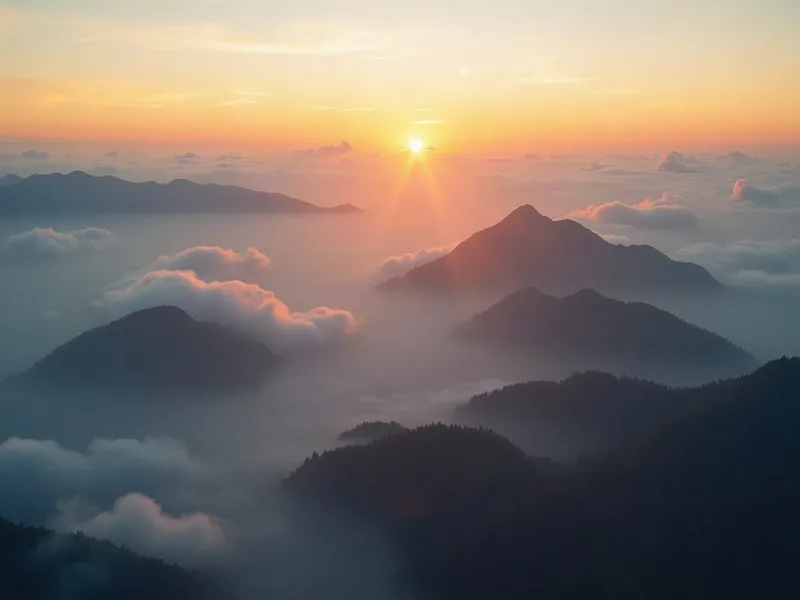 Misty mountain ranges above the clouds at sunrise